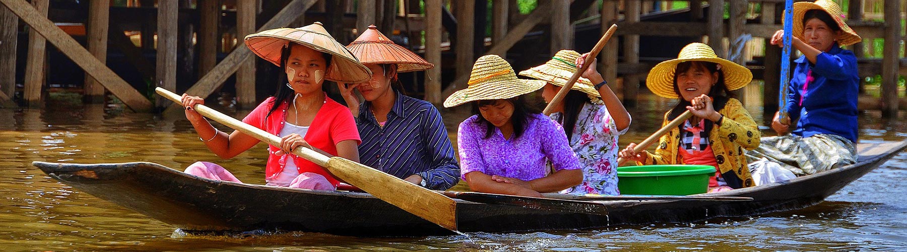 women paddling a long boat